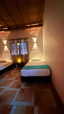 a small bedroom with a bed in a room at Maravilla de cabaña grupal 5-10 personas parking, wifi, campestre, cercana in Jardin