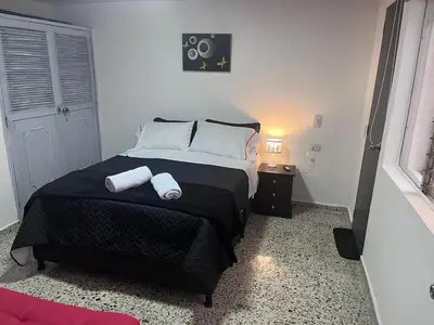 a bedroom with a bed with two towels on it at Edificio SantaMarta Medellín in Medellín