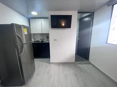 a kitchen with a refrigerator and a counter top at Edificio SantaMarta Medellín in Medellín