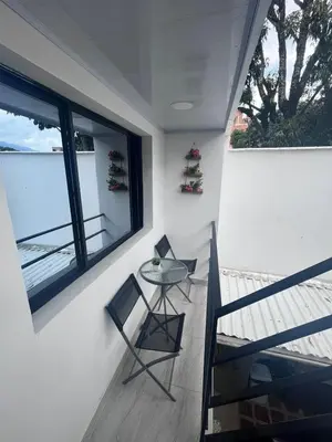 a balcony with a table and chairs and a window at Edificio SantaMarta Medellín in Medellín