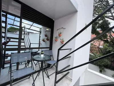 a small balcony with a table and chairs on a building at Edificio SantaMarta Medellín in Medellín