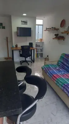 a bedroom with chairs and a bed and a desk at Amplio ApartaStudio en Boston in Medellín