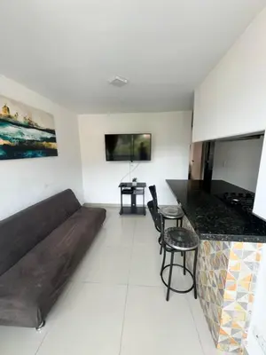 a living room with a couch and a table at Amplio ApartaStudio en Boston in Medellín