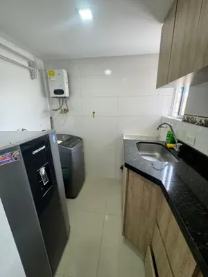 a small kitchen with a sink and a refrigerator at Amplio ApartaStudio en Boston in Medellín