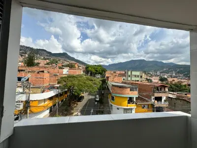 a view of a city street from a window at Amplio ApartaStudio en Boston in Medellín