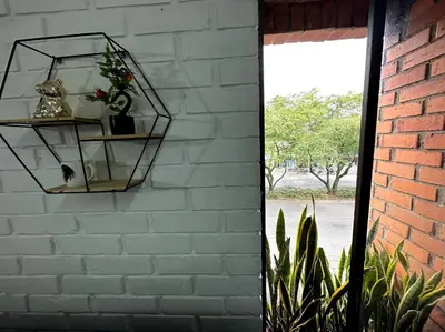 a brick wall with two shelves with plants on it at ApartaStudio El Poblado in Medellín