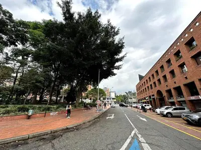 a person walking down a street in a city at ApartaStudio El Poblado in Medellín