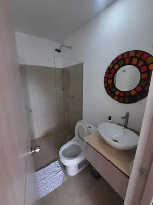 a bathroom with a toilet and a sink and a mirror at Citadela Di Sole - Apartamento in Santa Fe de Antioquia