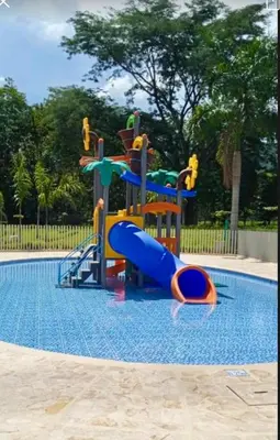 a playground in a swimming pool with a water slide at Citadela Di Sole - Apartamento in Santa Fe de Antioquia