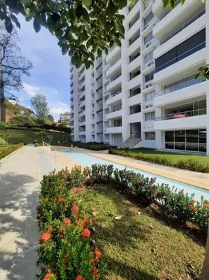 a large apartment building with a flower garden in front of it at Citadela Di Sole - Apartamento in Santa Fe de Antioquia