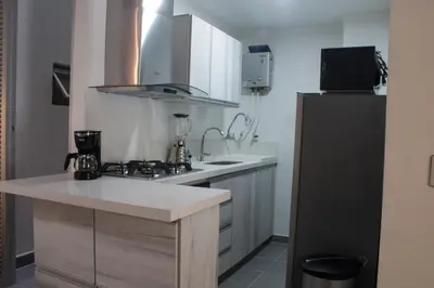 a kitchen with a sink and a stove top oven at Espectacular apartaestudio en sabaneta! in Sabaneta