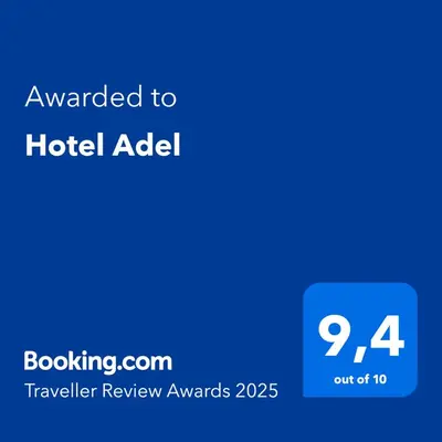 a blue sign with the text awarded to a hotel addel at Hotel Adel in Manizales
