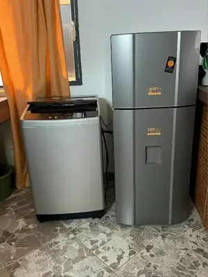 a refrigerator and a water cooler next to each other at Aparta Suite Torre De Prado 303 in Medellín