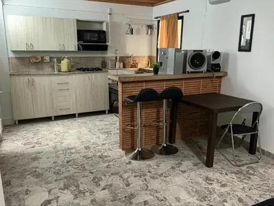 a kitchen with a table and two stools in it at Aparta Suite Torre De Prado 303 in Medellín