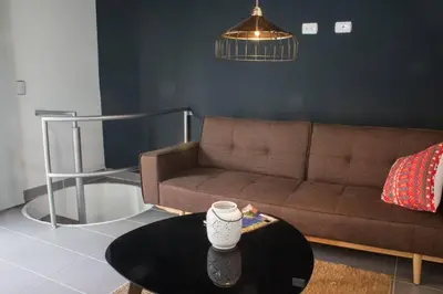 a living room with a couch and a coffee table at Espectacular apartamento Duplex VIP 501 con jacuzzy in Sabaneta