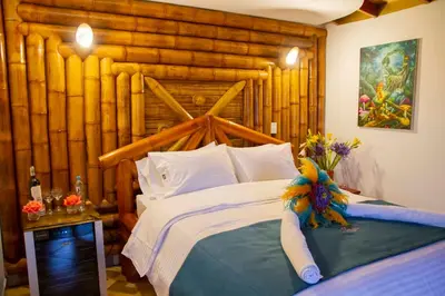 a bedroom with a large bed with a wooden wall at Jardin de los Silleteros Agro Parque Hotel in Santa Elena