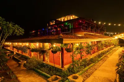 a building with lights on it at night at Jardin de los Silleteros Agro Parque Hotel in Santa Elena