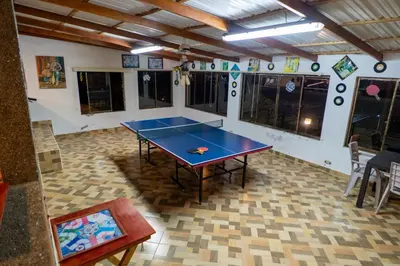 a ping pong table in the middle of a room at Jardin de los Silleteros Agro Parque Hotel in Santa Elena