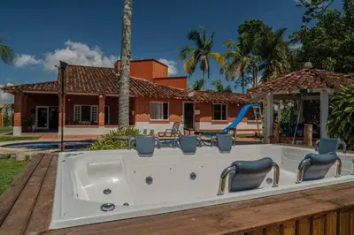 a jacuzzi tub in the backyard of a house at Finca El paraíso Guatape in Guatapé