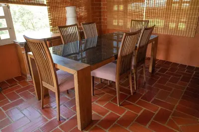 a dining room with a table and chairs and a table and chairsktop at Finca El paraíso Guatape in Guatapé