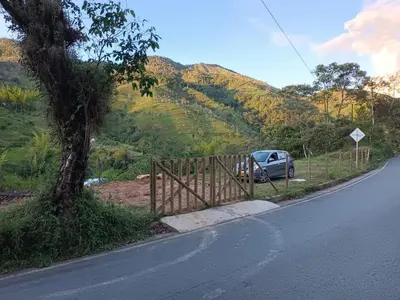 a car parked on the side of a road with a fence at Hospedajes el Jardin cabaña in Concepción