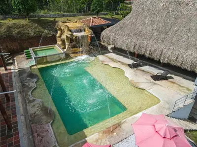 an overhead view of a swimming pool with a water fountain at Parcela la cascada in Doradal