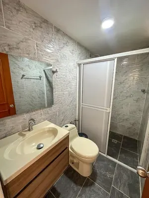 a bathroom with a toilet and a sink and a shower at Parcela la cascada in Doradal