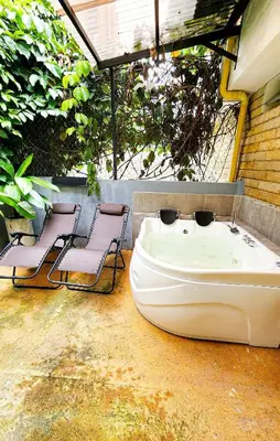 two chairs and a white boat on a patio at Monet Luxury Loft in Medellín