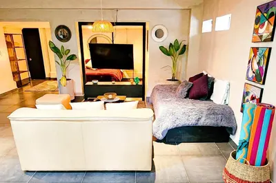 a living room with two white couches and a television at Monet Luxury Loft in Medellín