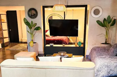 a living room with a couch and a tv at Monet Luxury Loft in Medellín