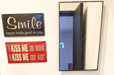 a mirror hanging on a wall with a smile sign at Monet Luxury Loft in Medellín