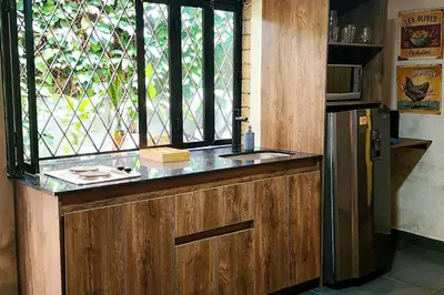 a kitchen with a window and a sink and a refrigerator at Monet Luxury Loft in Medellín
