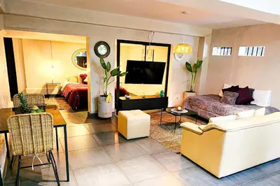 a living room with a couch and a tv at Monet Luxury Loft in Medellín