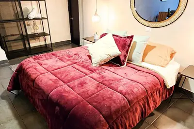 a bedroom with a large bed with a red blanket at Monet Luxury Loft in Medellín