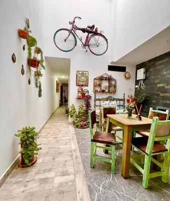 a room with a table and a bike hanging from the ceiling at Paisa Territory Jardin in Jardin