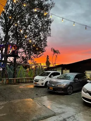 three cars parked in a parking lot at sunset at El eden in Manizales