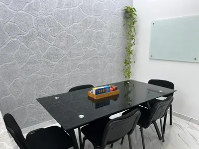 a black table with black chairs and a board at Black and White Mariquita Tolima in Mariquita