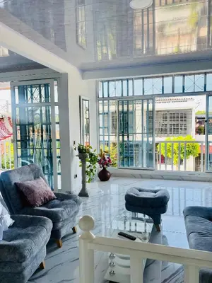 a living room with two couches and a table and windows at Black and White Mariquita Tolima in Mariquita