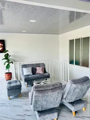 a living room with two chairs and a couch at Black and White Mariquita Tolima in Mariquita