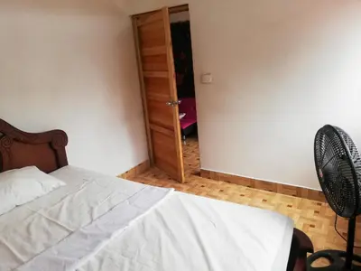 a bedroom with a bed and a closet with a fan at Apartamento Barbie 3 in Mutatá