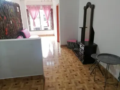 a living room with a wood floor and a stove at Apartamento Barbie 3 in Mutatá
