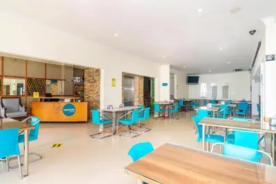 a dining room with tables and blue chairs at HOTEL OASIS in Rionegro