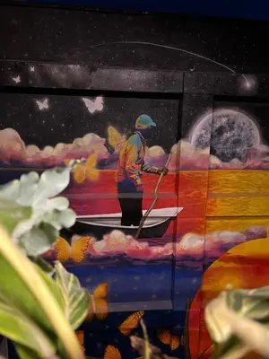 a painting of a man rowing a boat at Los Patios Cool Living in Medellín
