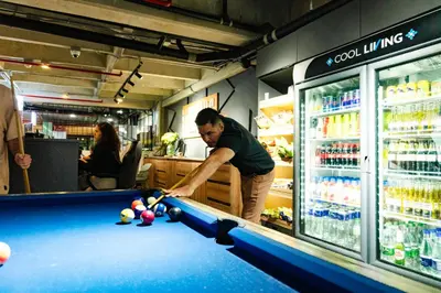 a man playing pool in a billiard table in a store at Los Patios Cool Living in Medellín