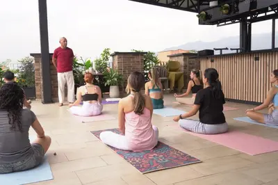 a group of people sitting in a yoga class at Los Patios Cool Living in Medellín