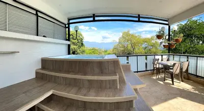 a hot tub on the balcony of a house at Duplex con jacuzzi y terraza privada in Santa Fe de Antioquia