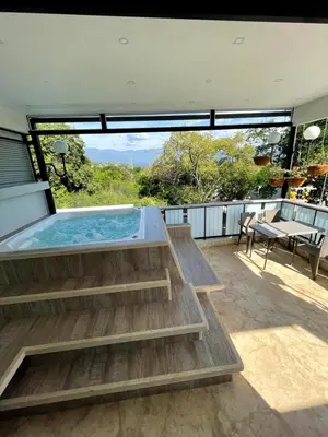 a hot tub on the deck of a house at Duplex con jacuzzi y terraza privada in Santa Fe de Antioquia