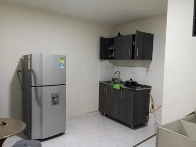 a kitchen with a stainless steel refrigerator and black cabinets at Aparta-estudio amoblado en Medellin, Campo Valdes in Medellín