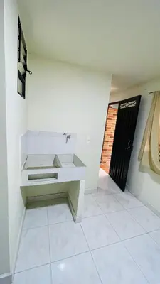 a white room with a bench and a door at Aparta-estudio amoblado en Medellin, Campo Valdes in Medellín