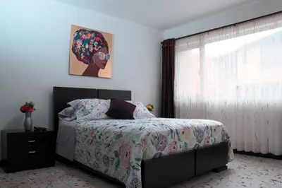 a bedroom with a bed and a window at Hospedaje juandi in Medellín